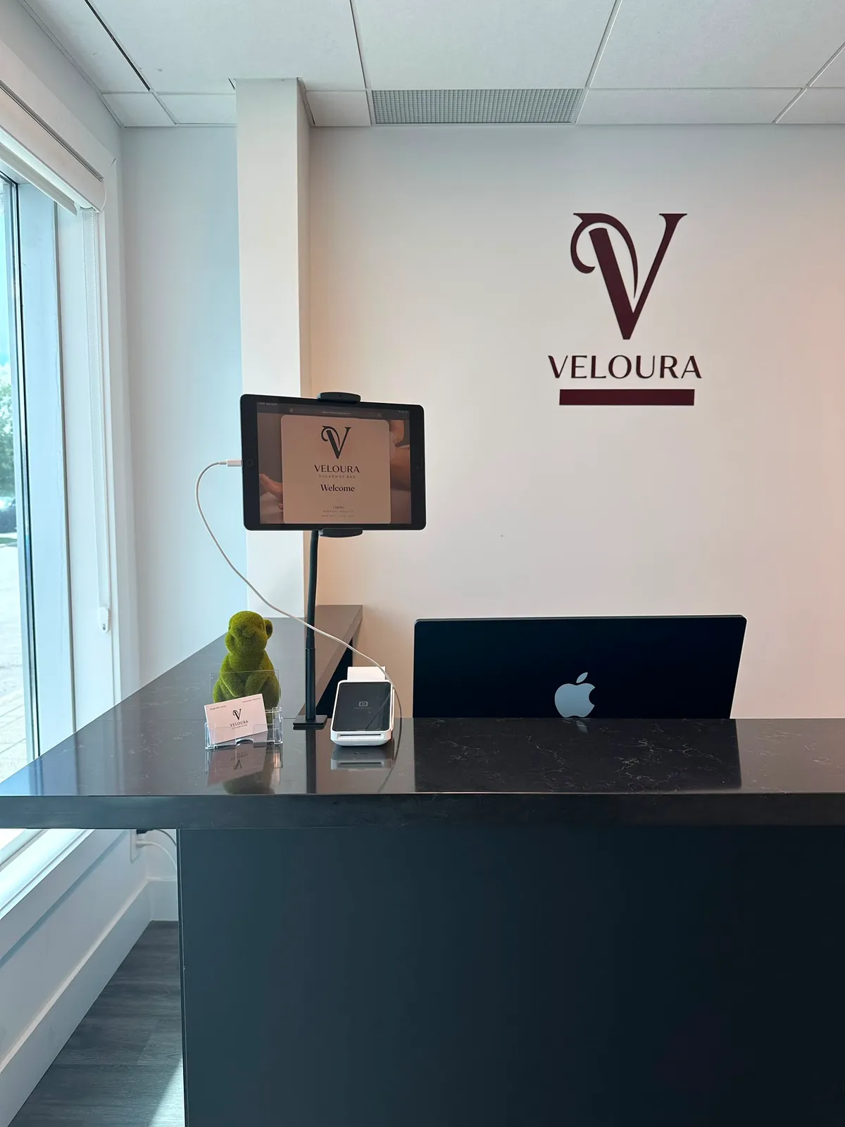 Self check-in iPad at the Veloura SugarWax Bar reception counter
